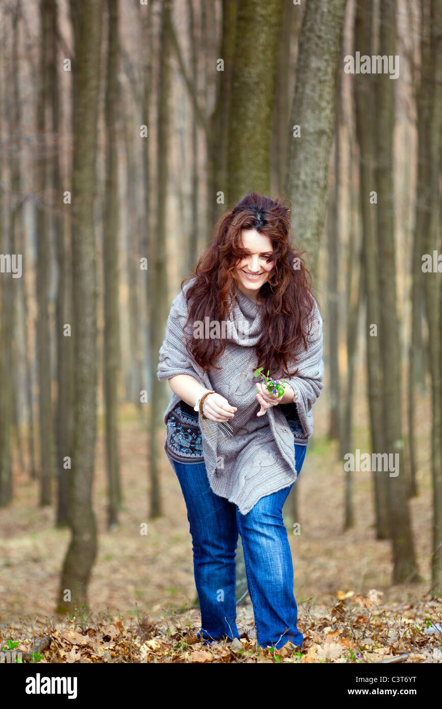 Young woman taking a walk in a beech forest Stock Photo - Alamy