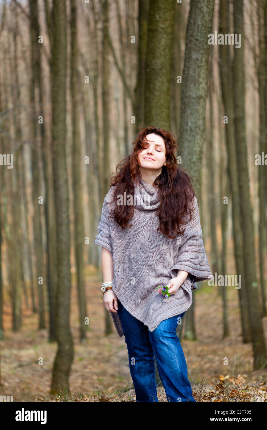Young woman taking a walk in a beech forest Stock Photo - Alamy