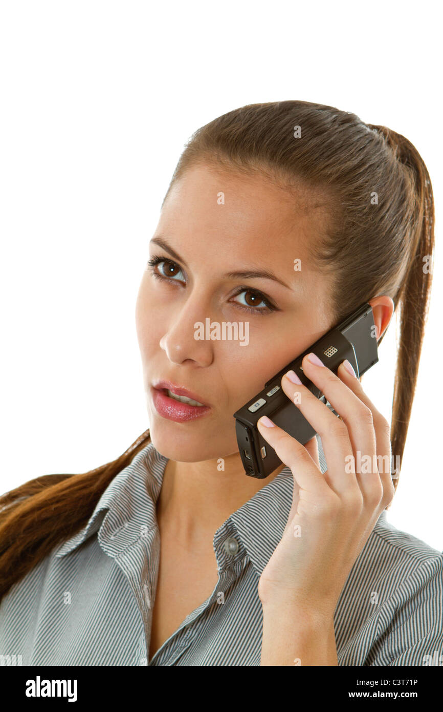 Serious young woman using mobile phone Stock Photo