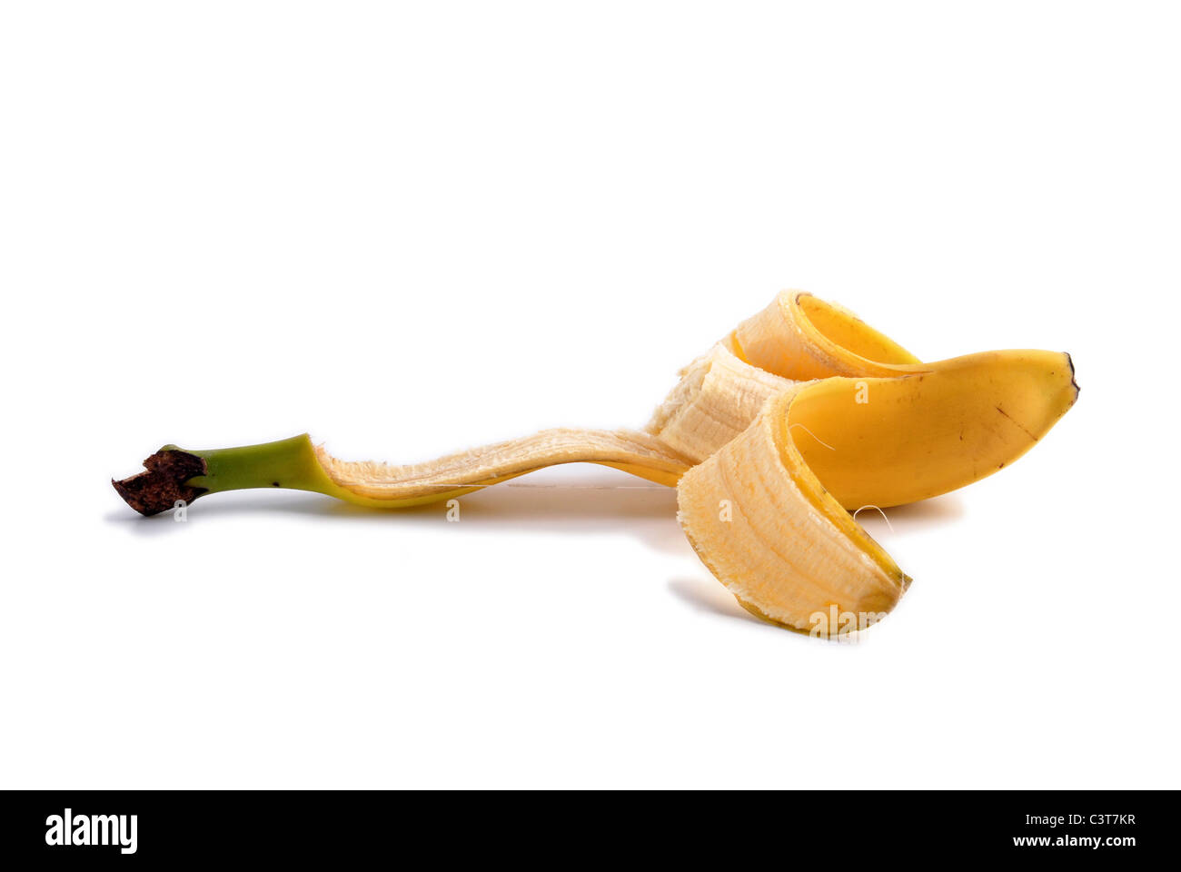 Peeled bitten banana. Ripe fruit isolated on white background Stock Photo