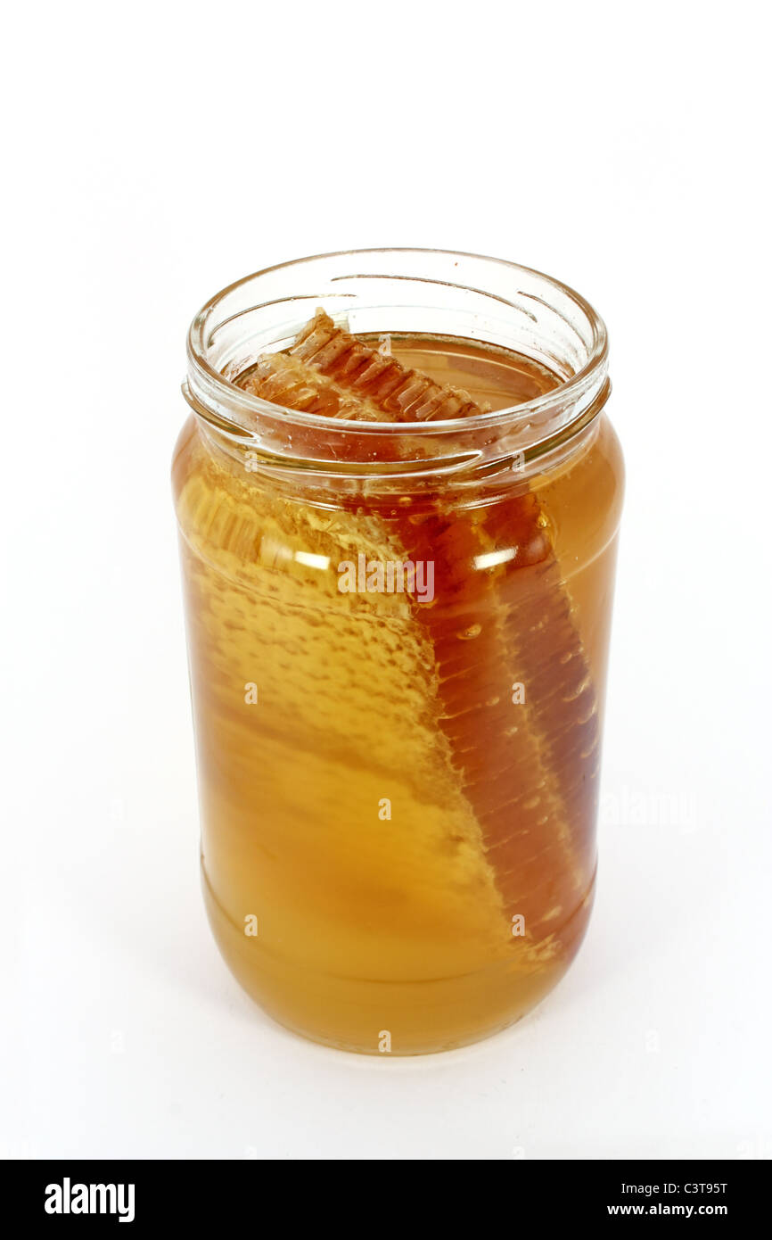 Glass jar full of honey with honeycomb, isolated on white Stock Photo -  Alamy