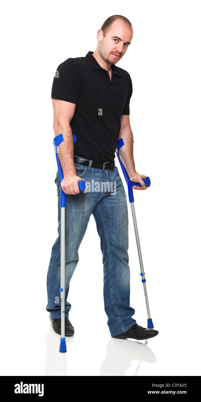 man with crutch isolated on white background Stock Photo