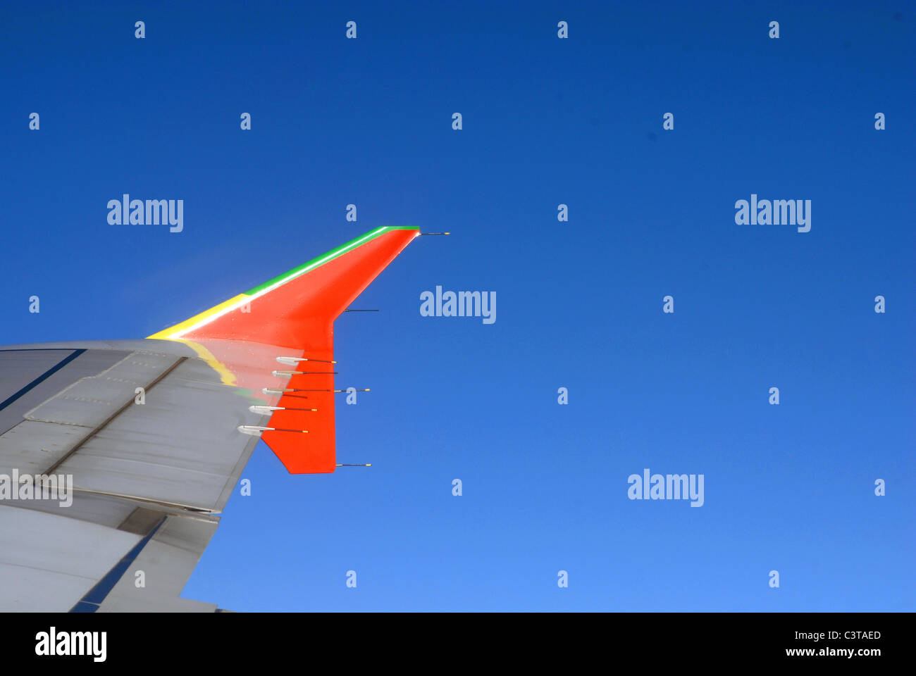 clear sky with airplane wings detail. Stock Photo