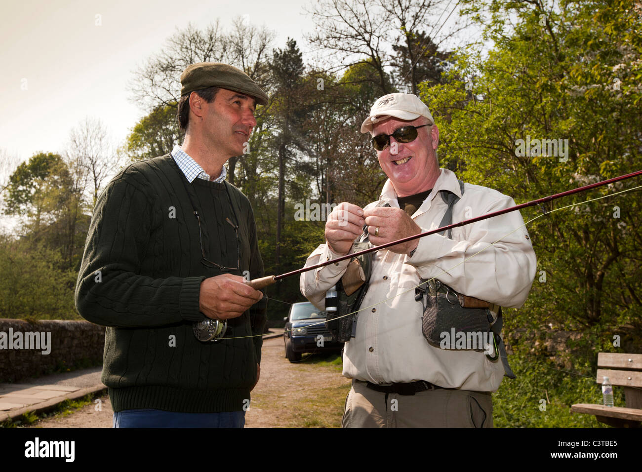 UK, Derbyshire, Peak District, Bakewell, man having fly fishing lesson