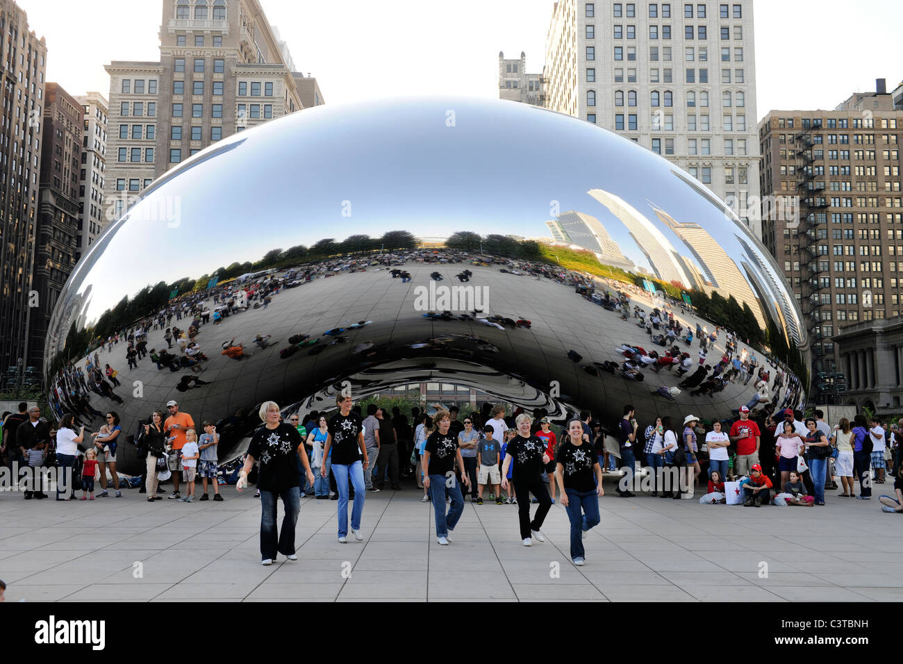Dancers perform in front of Cloud Gate Sculpture in Chicago's Millenium Park. Stock Photo