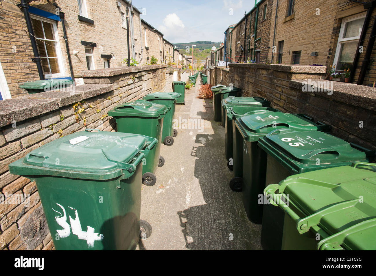 Rubbish bins on a back alley between terraced houses in Saltaire, Yorkshire, UK Stock Photo Alamy