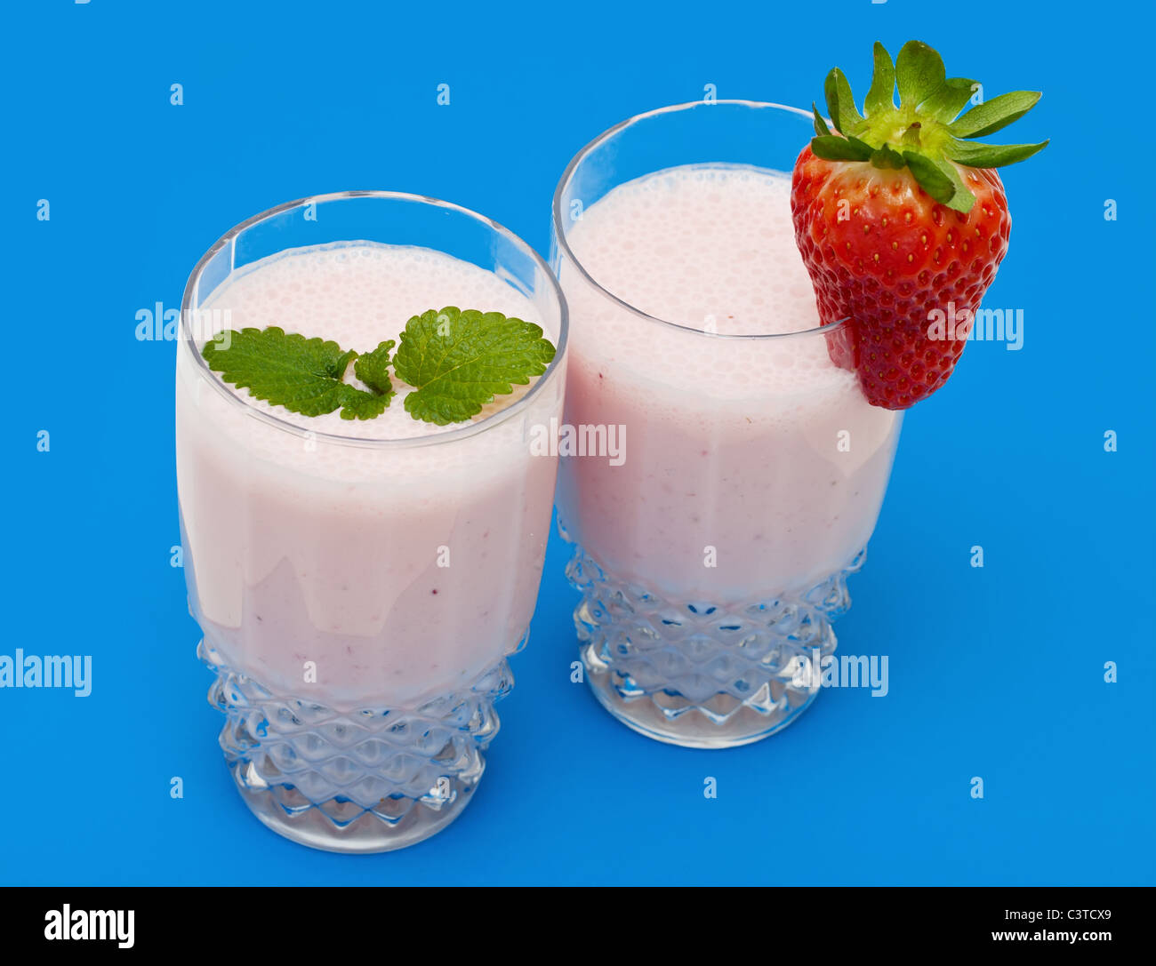 Strawberry milkshake on a blue background Stock Photo Alamy