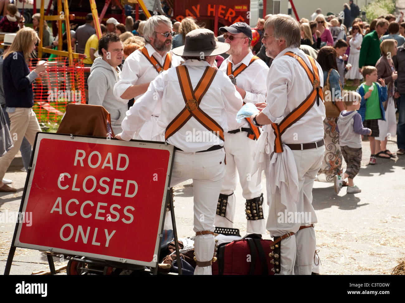 Morris men drinking by the Road Closed sign, Reach Village fair, Cambridgeshire UK Stock Photo