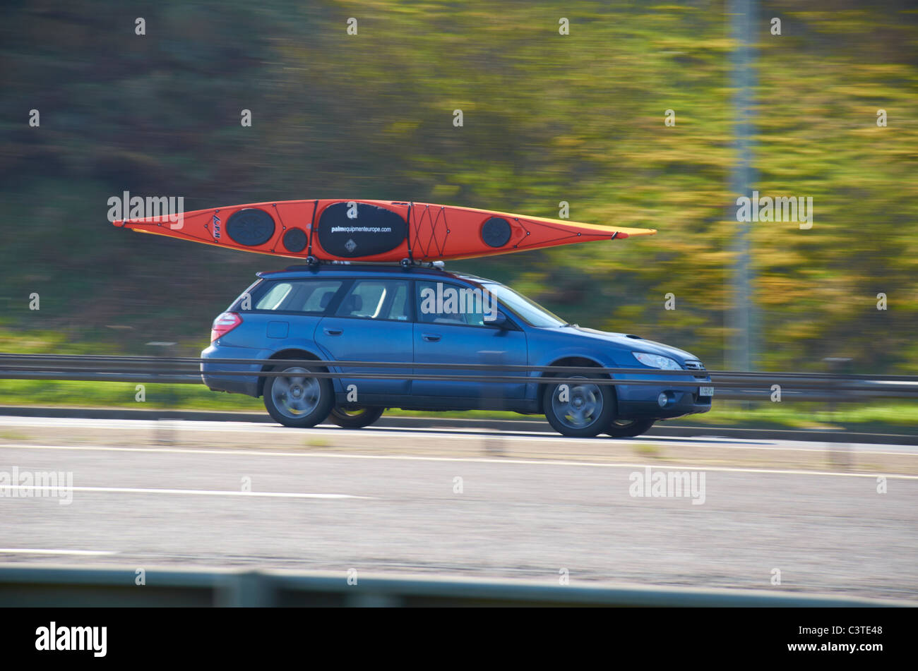 Boat on the roof of a car (on the M62). Stock Photo