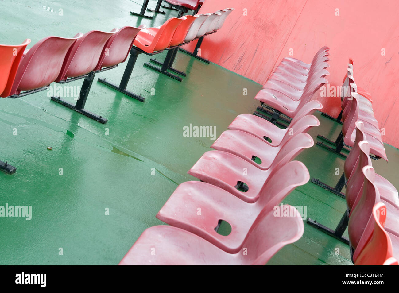 Rows of red seats on the deck of a ferry. Stock Photo
