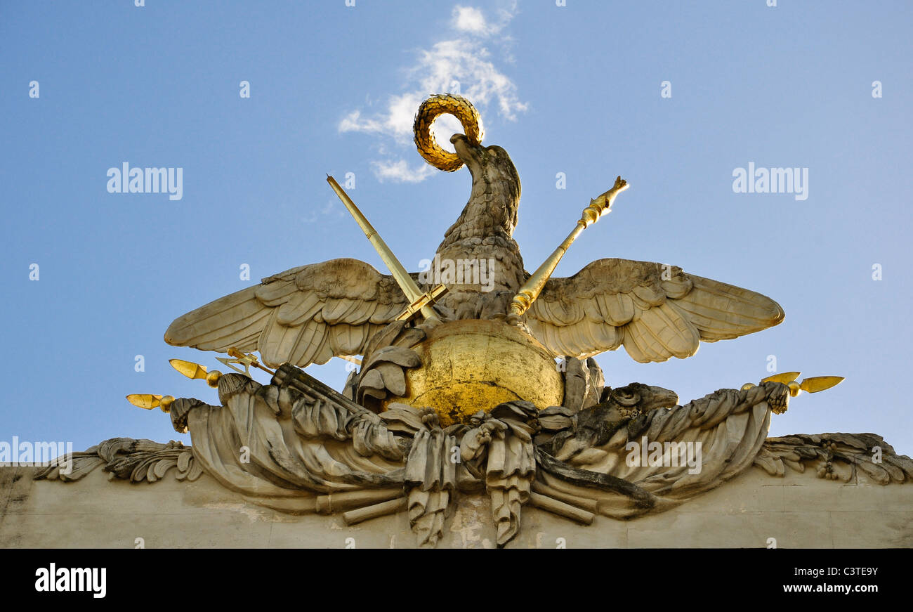 stone eagle bearing sword, staff and laurel wreath, on top of the gloriette, vienna, austria Stock Photo
