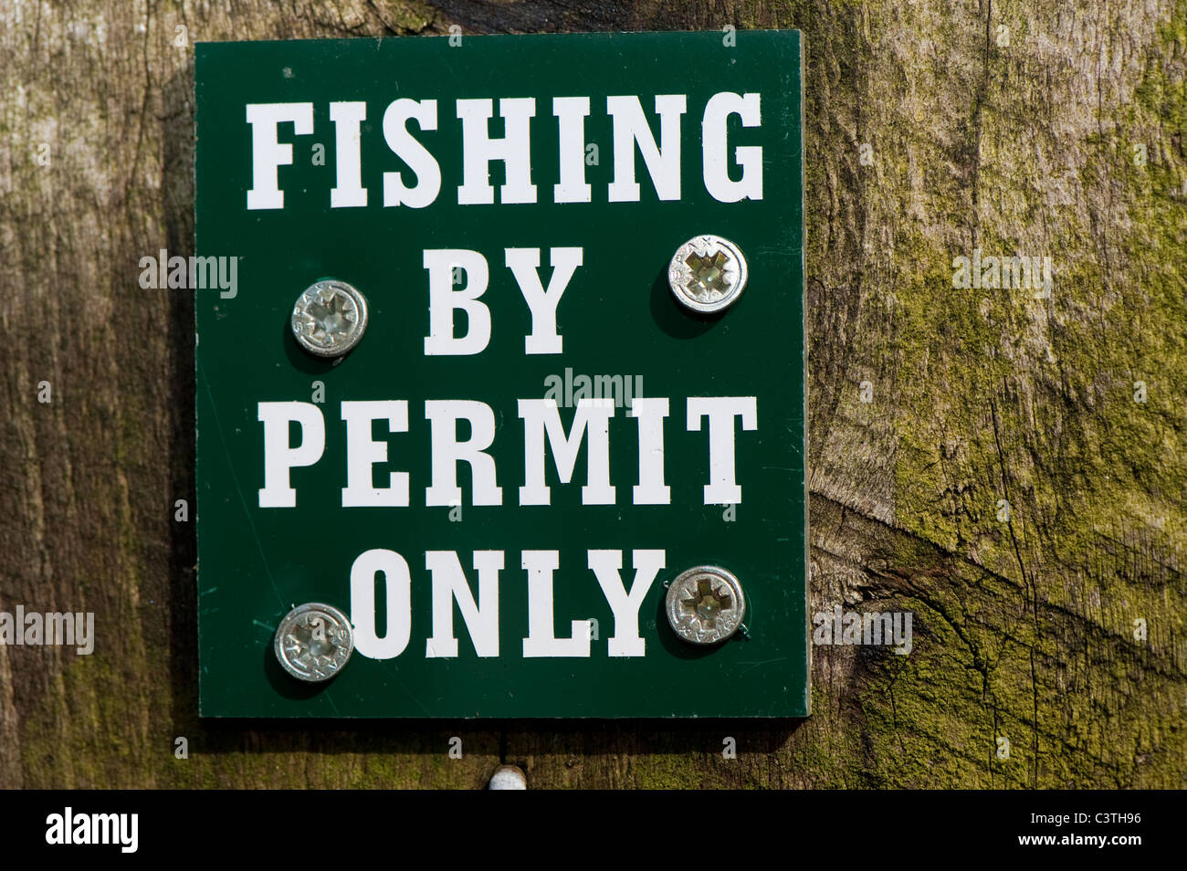 No fishing without permit sign on post near a lake Stock Photo