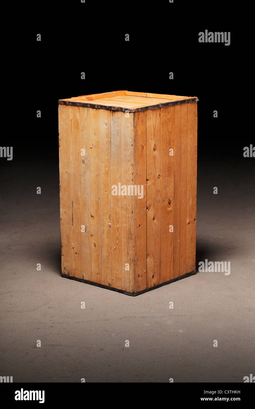 Old wooden crate on dirty concrete floor Stock Photo