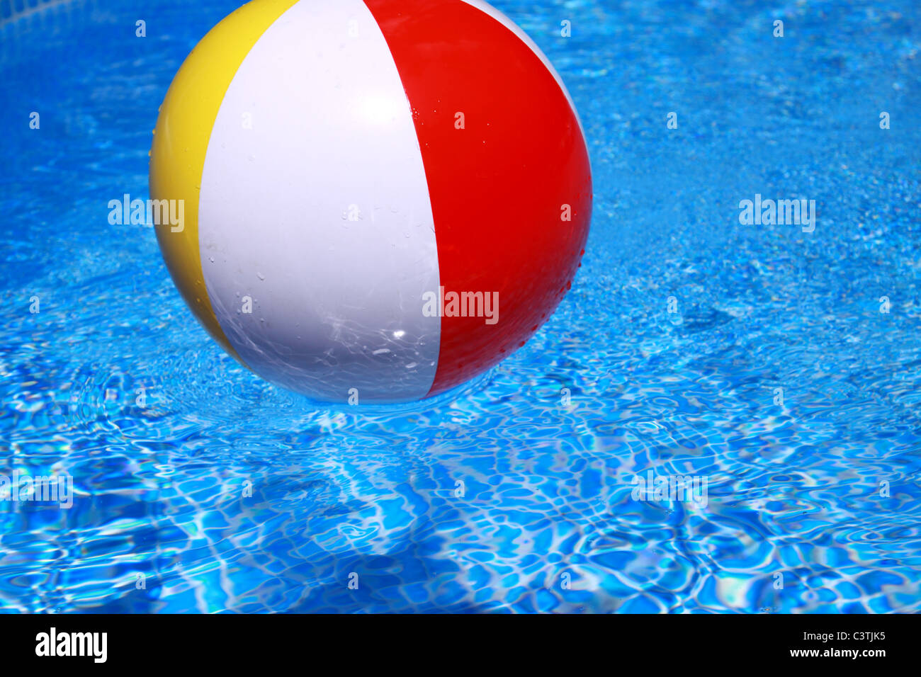 Beach ball floating on the calm water Stock Photo