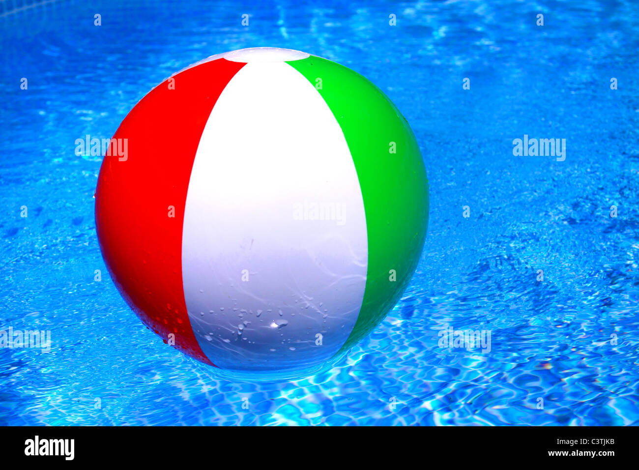 Beach ball floating on the calm water Stock Photo