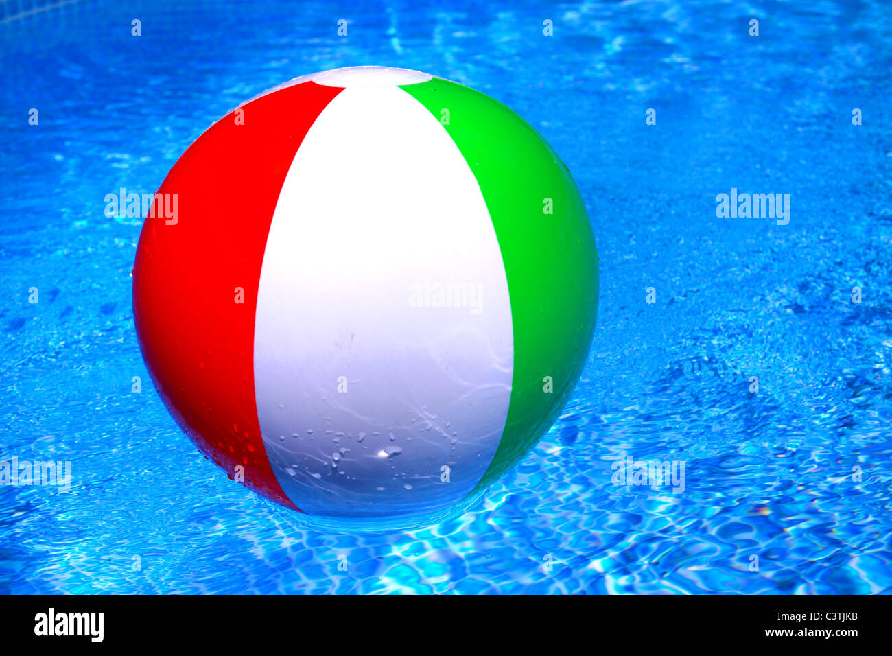 Beach ball floating on the calm water Stock Photo Alamy