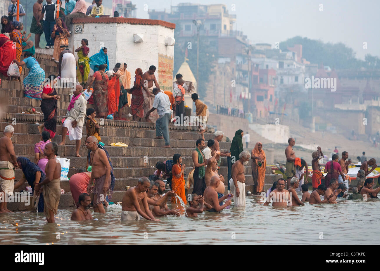 Indian pilgrims bathing in the River Ganges, Varanasi, Uttar Pradesh, India. Religious pilgrimage for Hindu people Stock Photo