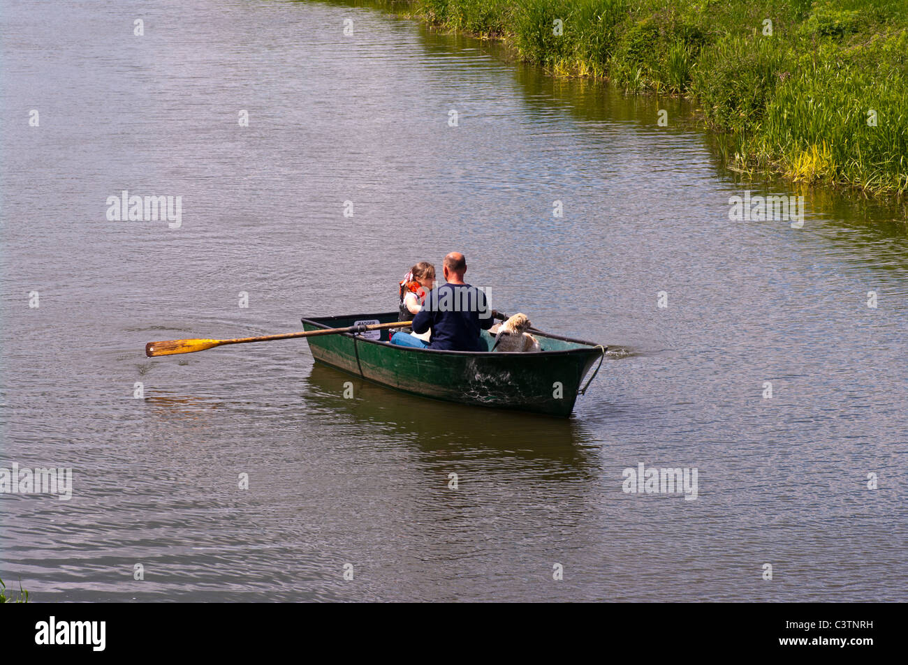 Father and Daughter With A Dog In A Rowing Boat Stock Photo