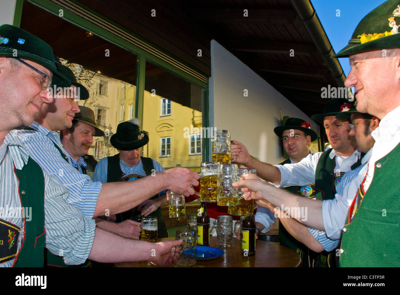 People drinking beer in the Viktualian Market im Munich, Germany. Stock Photo