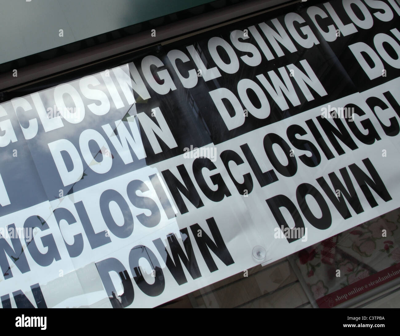 Closing Down sign in retail shop window Stock Photo