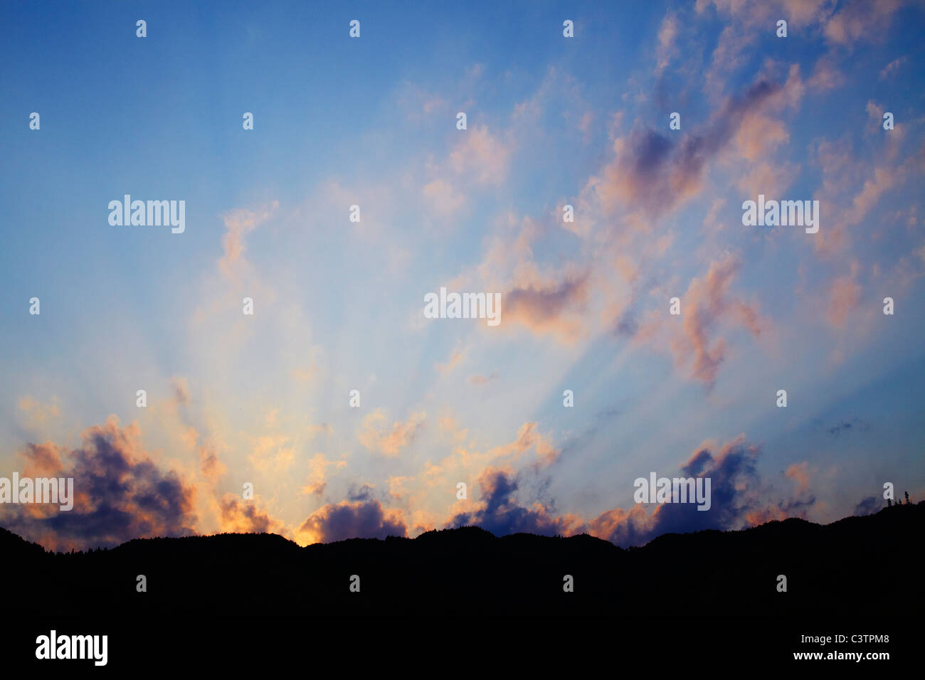 Sunset Over Mountains Stock Photo - Alamy