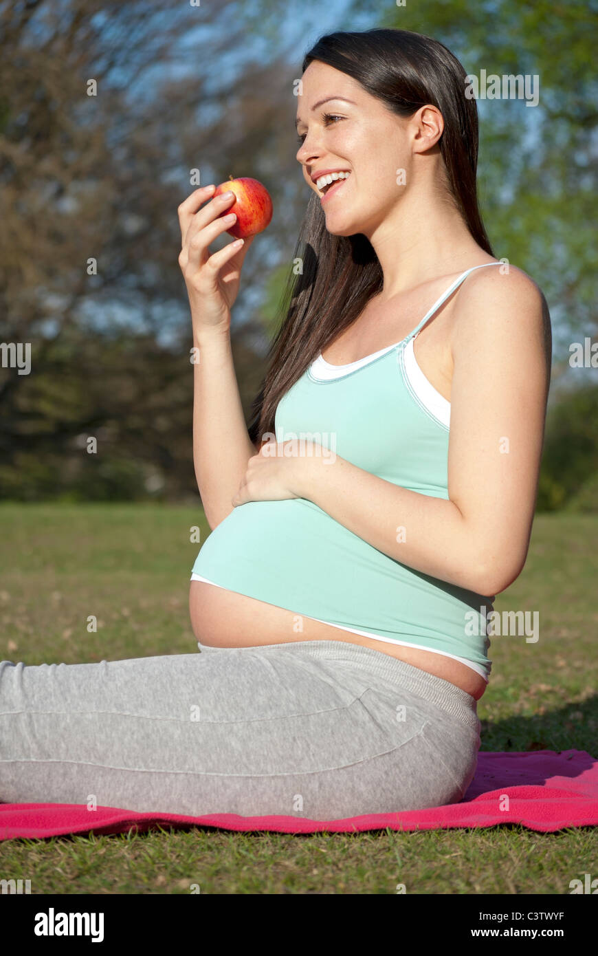 Pregnant woman eating healthy apple Stock Photo Alamy