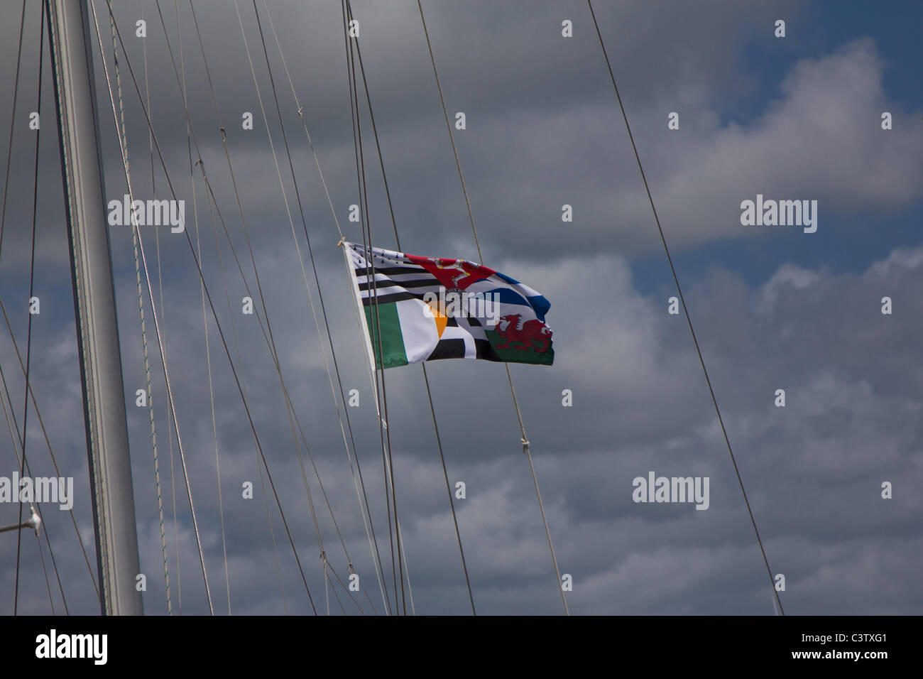 Celtic flag hist on a sailing boat in Caernarfon Marina Stock Photo - Alamy