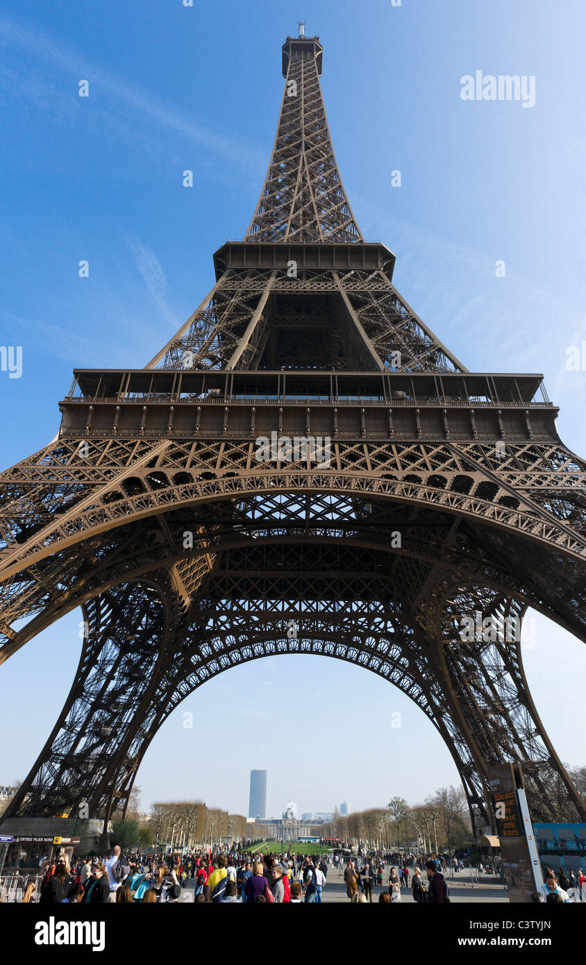 Tourists beneath the Eiffel Tower, Champ de Mars, Paris, France Stock Photo
