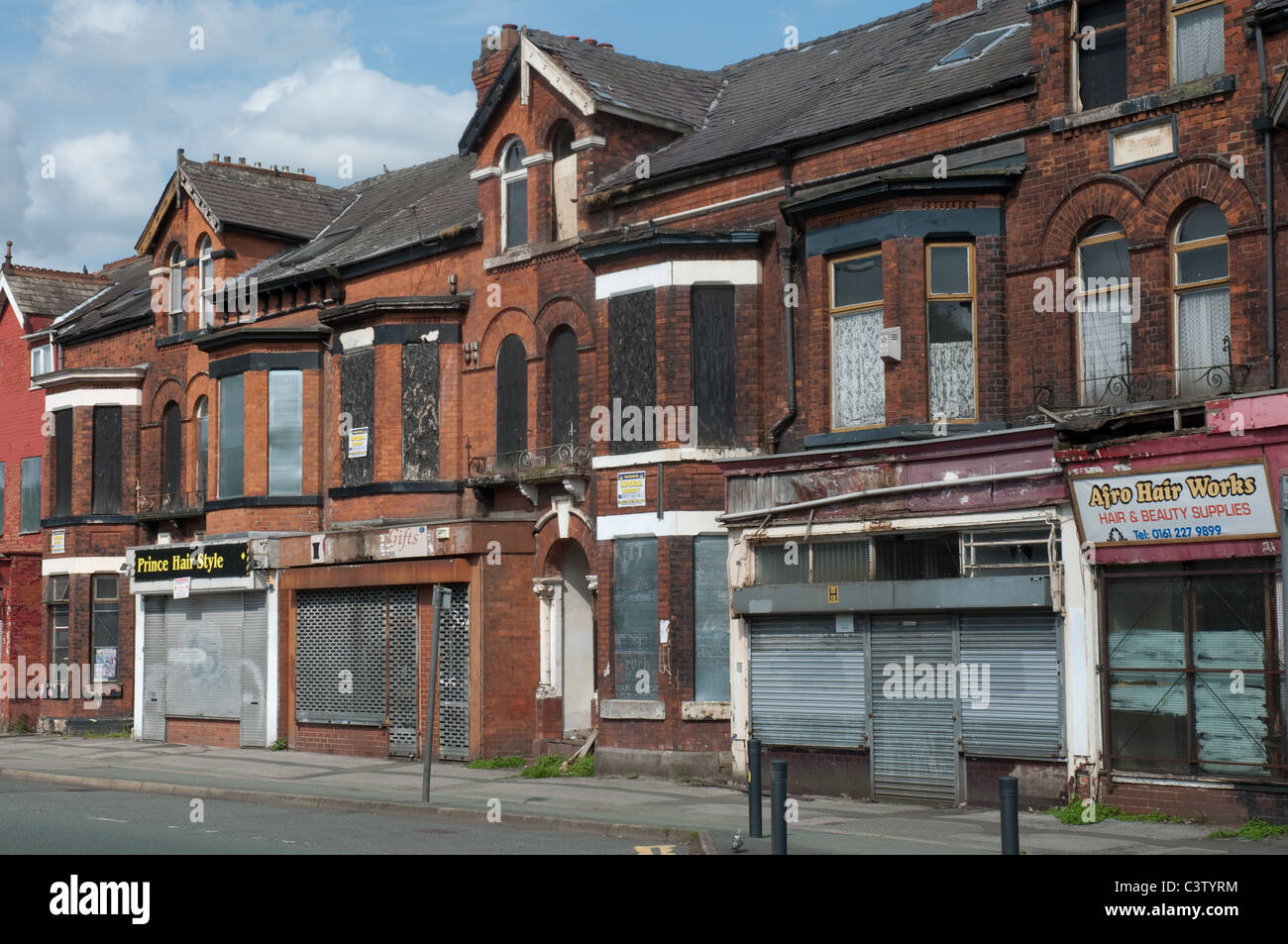 Row of terraced shops Princess Road,Moss Side,Manchester Stock Photo