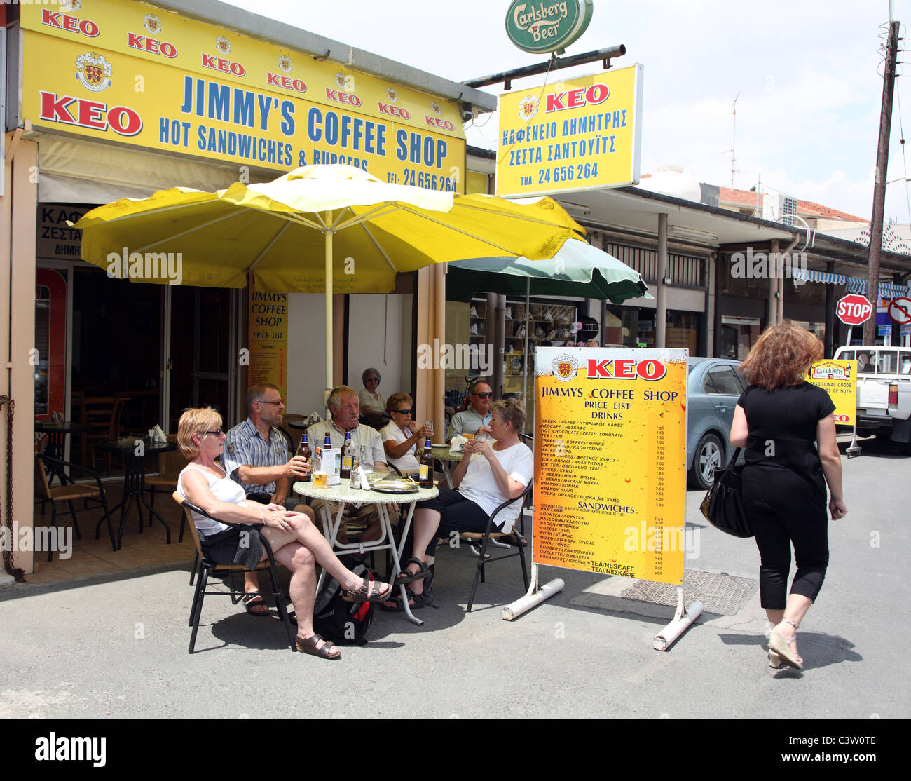 tourists watch a redhead go by, Jimmy's Coffee Shop, Larnaka, Cyprus