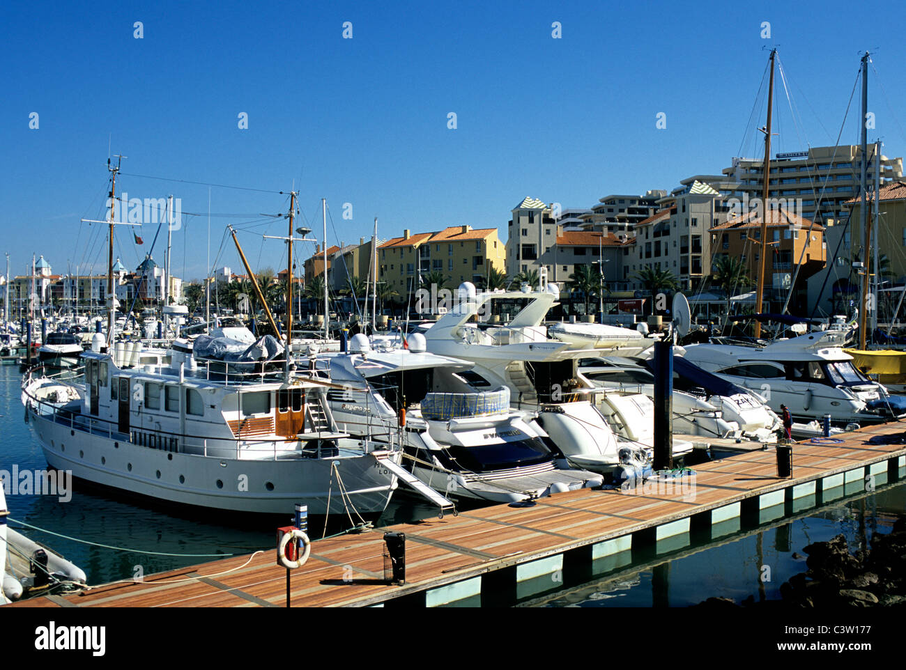 Sail boats and motor yachts moored at Vilamoura marina, in southern Portugal's Algarve province Stock Photo