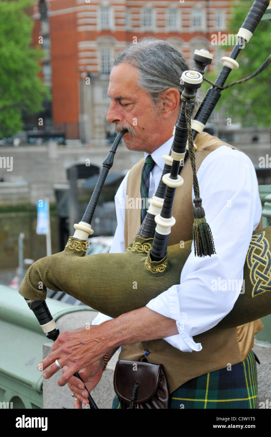 man playing bagpipes Scottish kilt drones wailing tradition Stock Photo