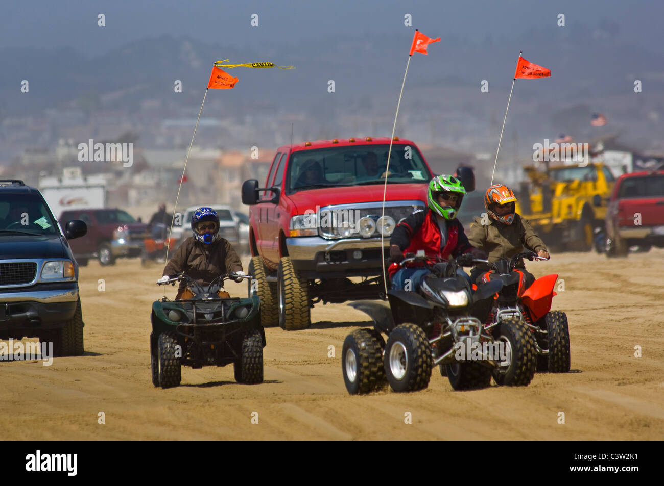 ATV's and passenger vehicles driving on the sand at Oceano Dunes State Vehicular Recreation Area, Oceano, California Stock Photo