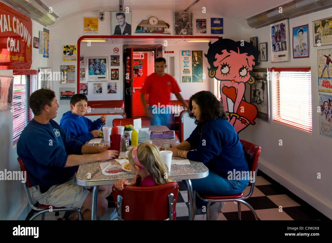 Family dining in the 1950's style Rock n' Roll Diner in an old converted train car coach, Oceano, California Stock Photo