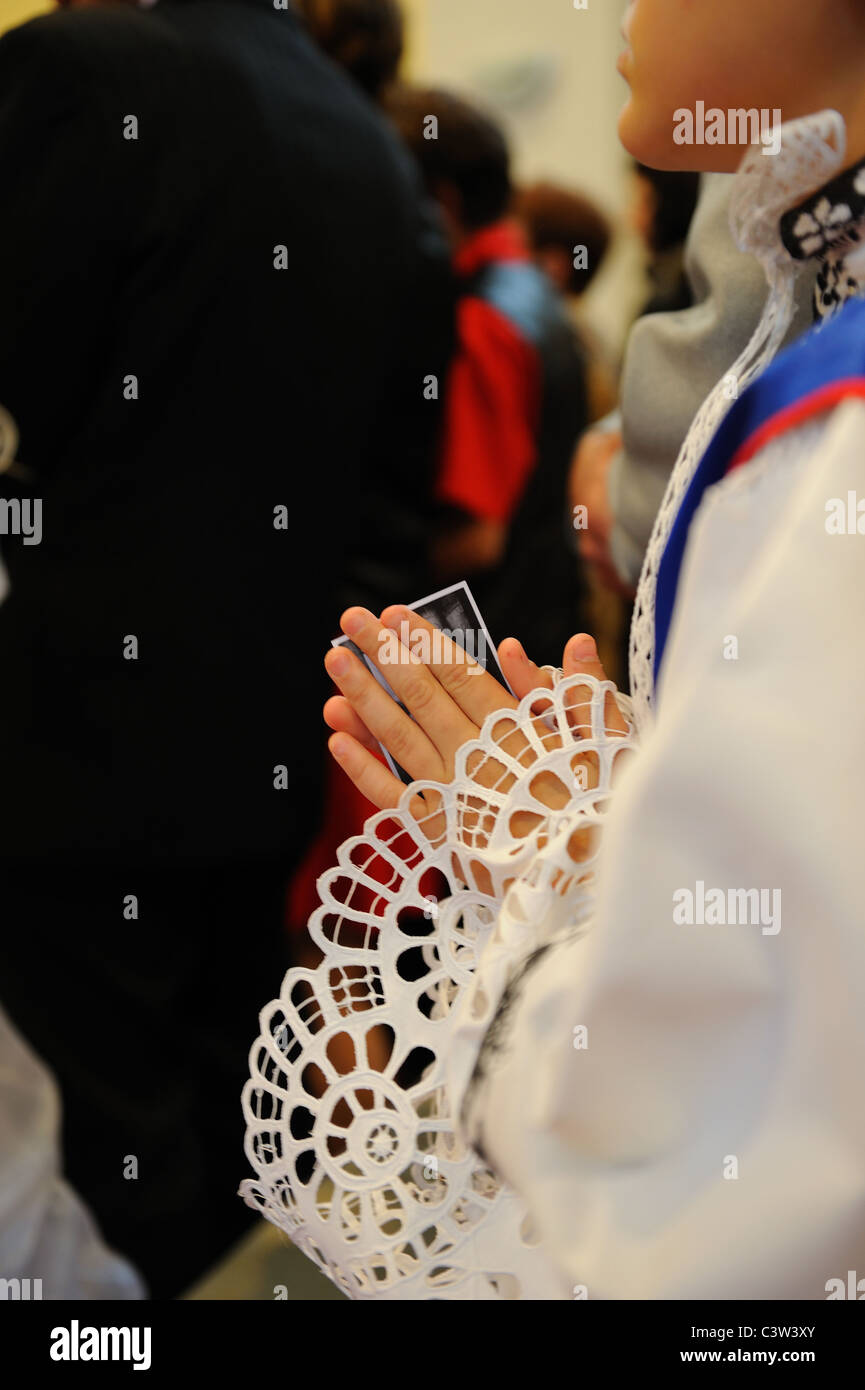 Holy Communion in Europe church. Young boy is praying with holly ...