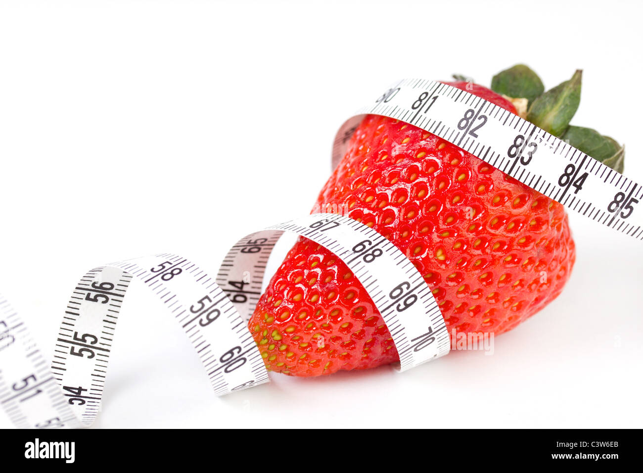 Strawberry with measure tape, closeup on white Stock Photo - Alamy