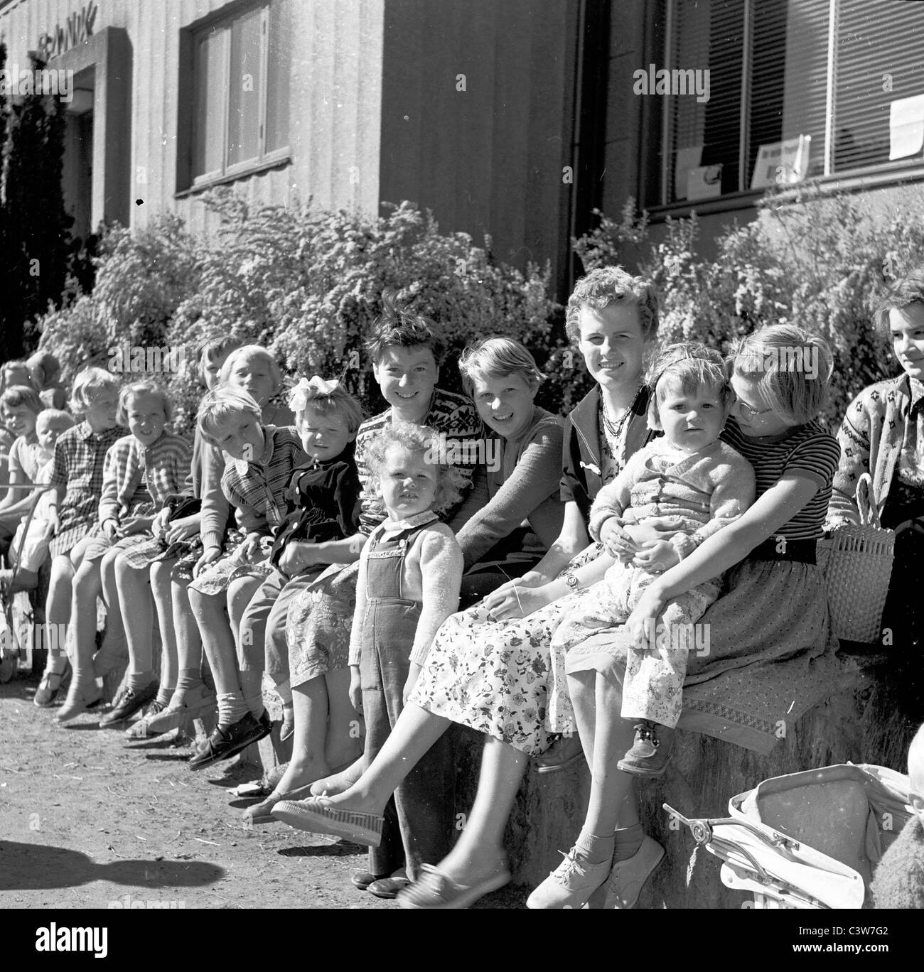 1950s. In this historical picture we see a group of young children with teachers outside a school in Oystese, Norway. Stock Photo