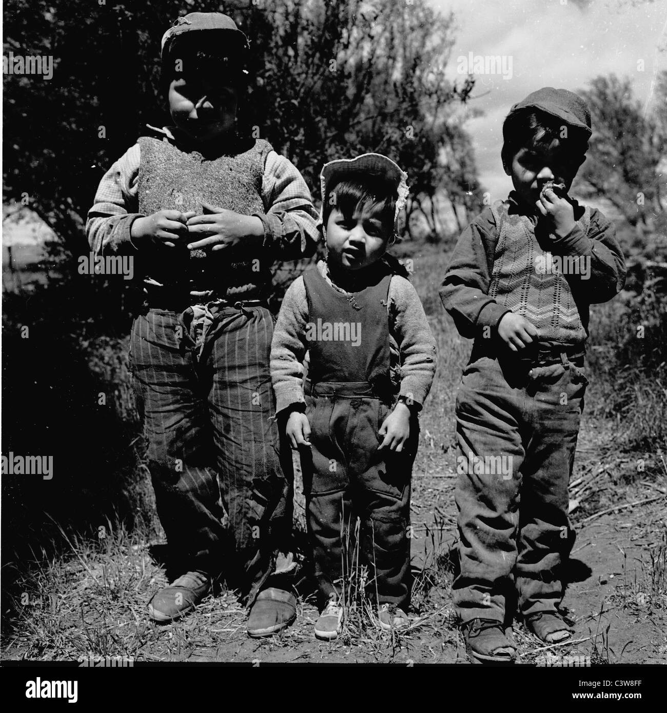 1950s.  An historical picture from this time of three small farm children at Bariloche, Argentina at the foothills of the Andes, Stock Photo
