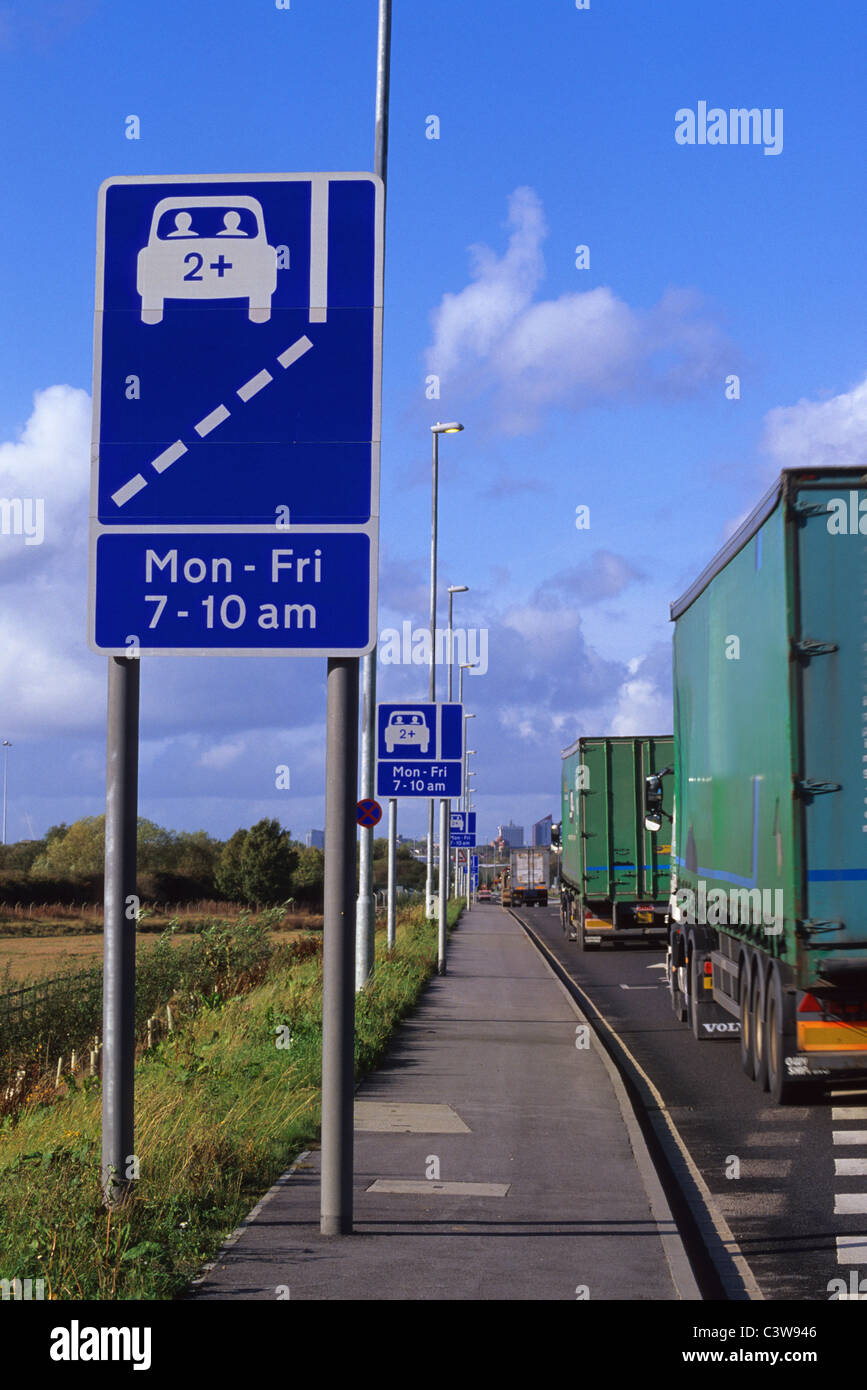 lorry passing warning roadsign of high occupancy lane ahead for vehicles carrying two or more people to ease congestion Leeds UK Stock Photo