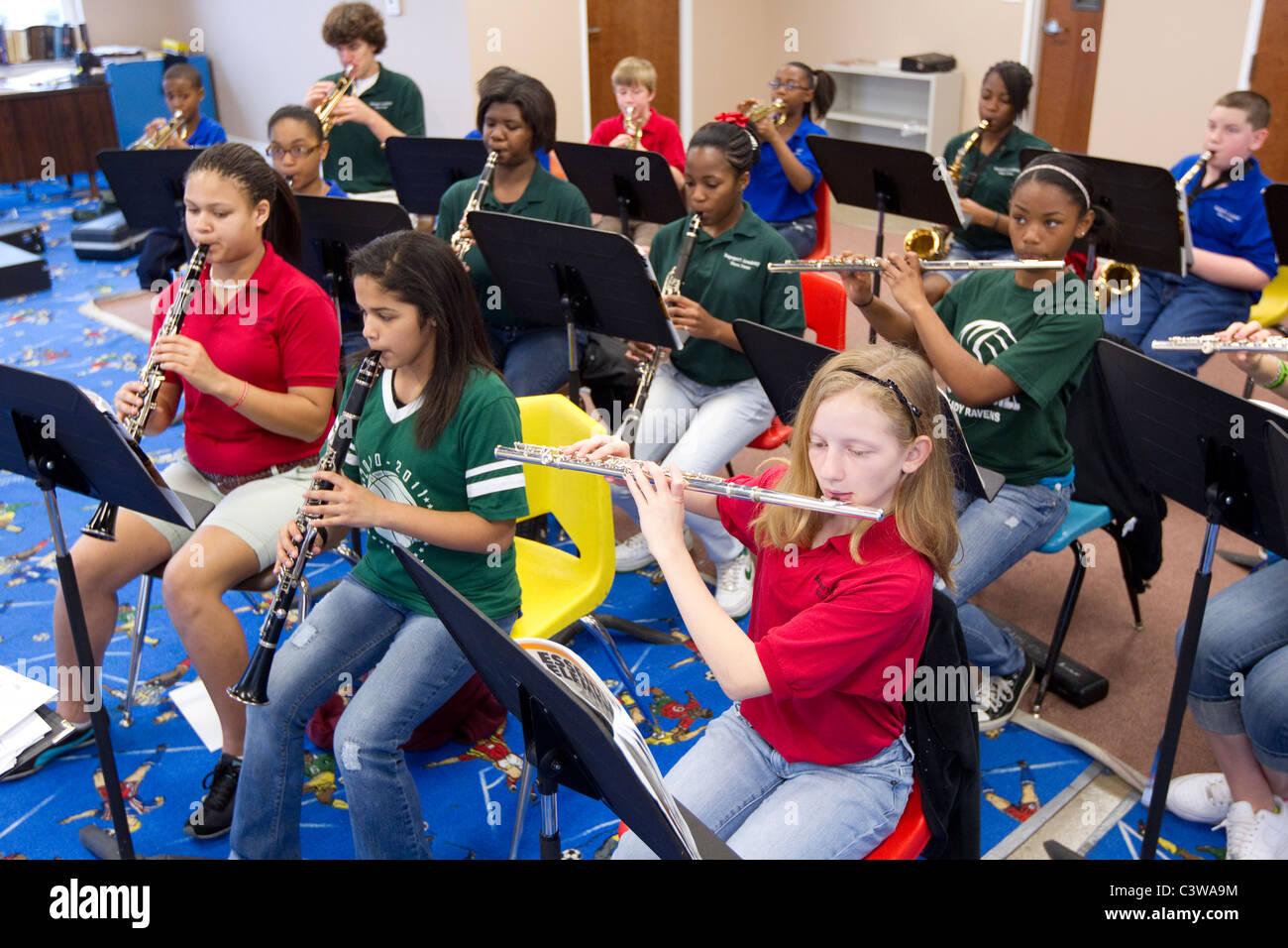Anglo, Hispanic and African-American middle school students play wind instruments during orchestra class at Rapoport Academy Stock Photo