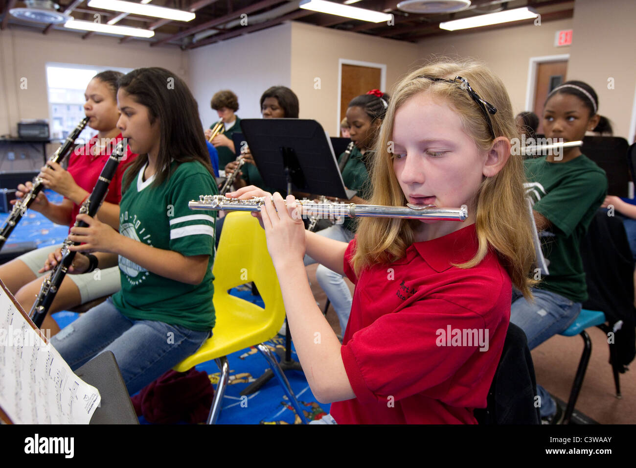 Anglo, Hispanic and African-American middle school students play wind instruments during orchestra class at Rapoport Academy Stock Photo