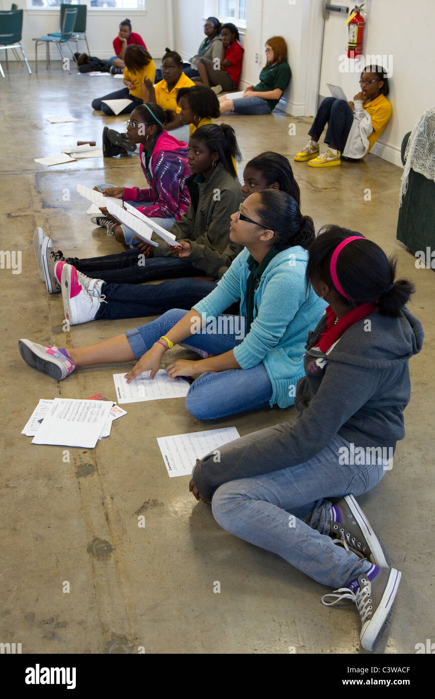 Middle school students look at sheet music before rehearsing song during music class at Rapoport Academy public charter school Stock Photo