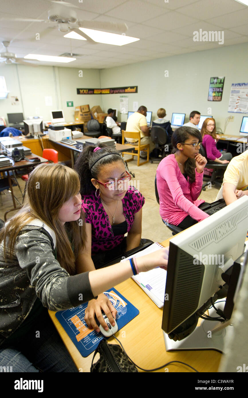 Teenage girls work together on computer during class at Rapoport