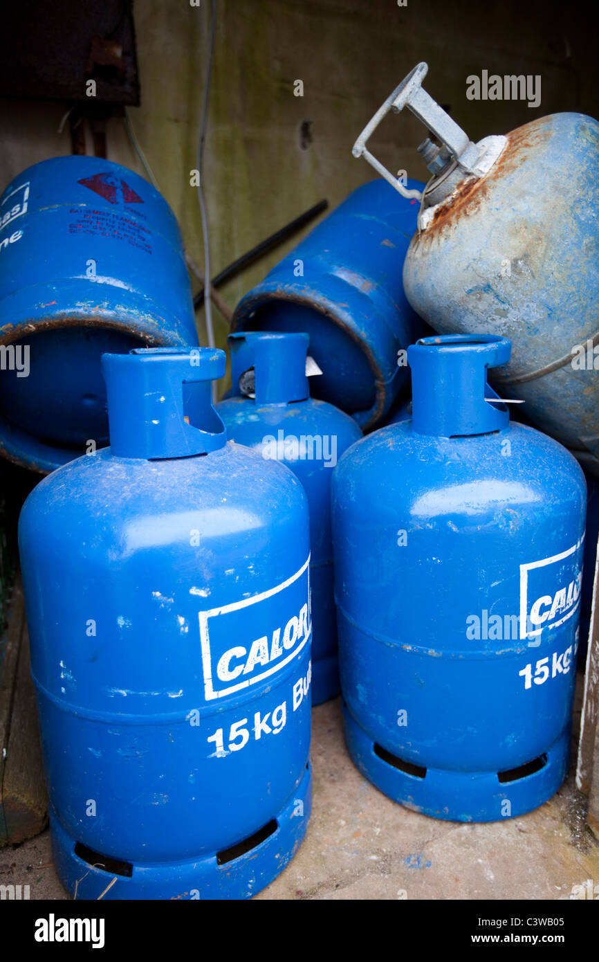 Blue Gas bottles left outdoors stored in a shed 117588 Caldey Stock Photo