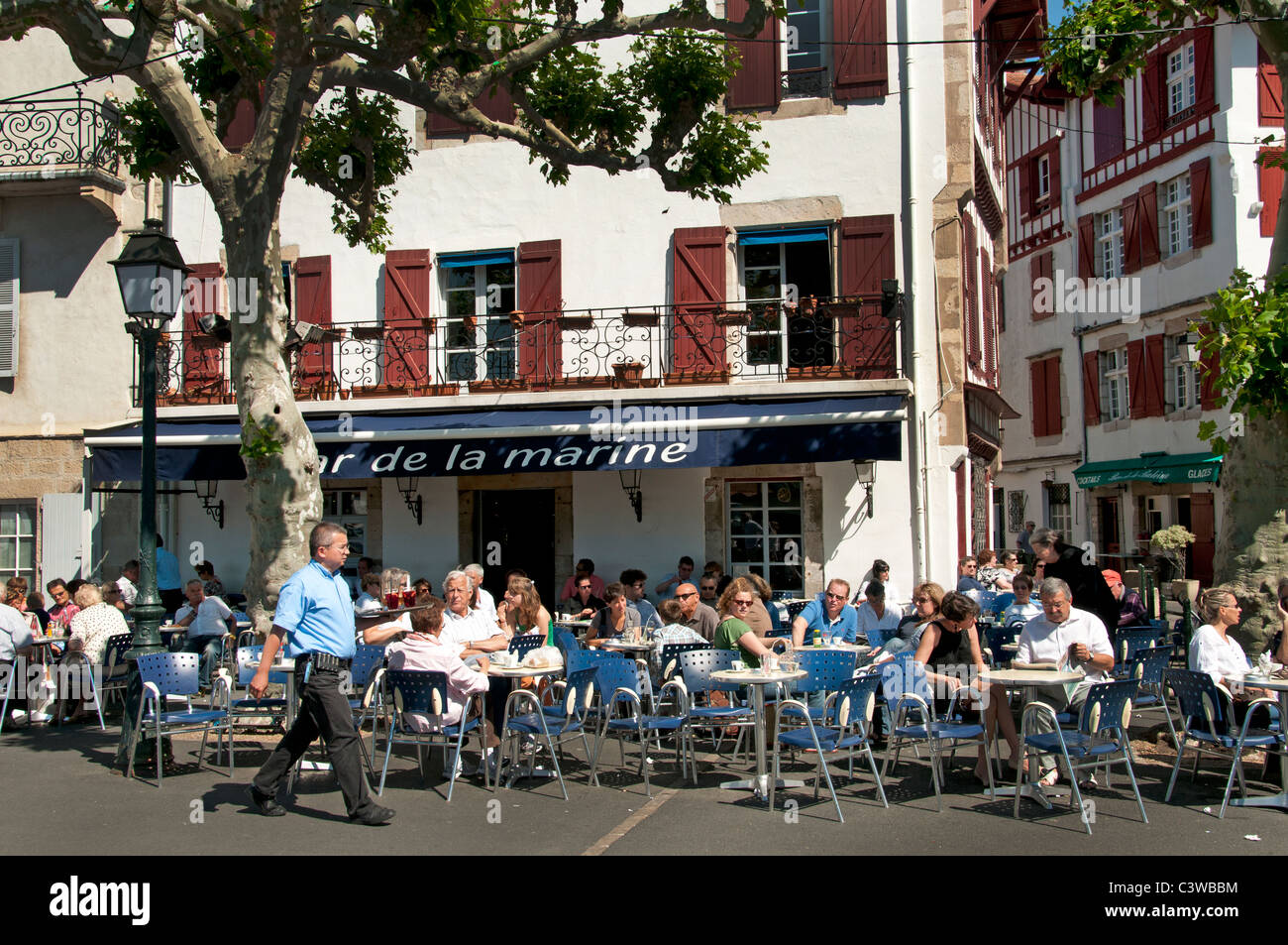 Place Loui XIV France St Jean de Luz Restaurant Bar Pub Pavement a typical fishing village Stock Photo