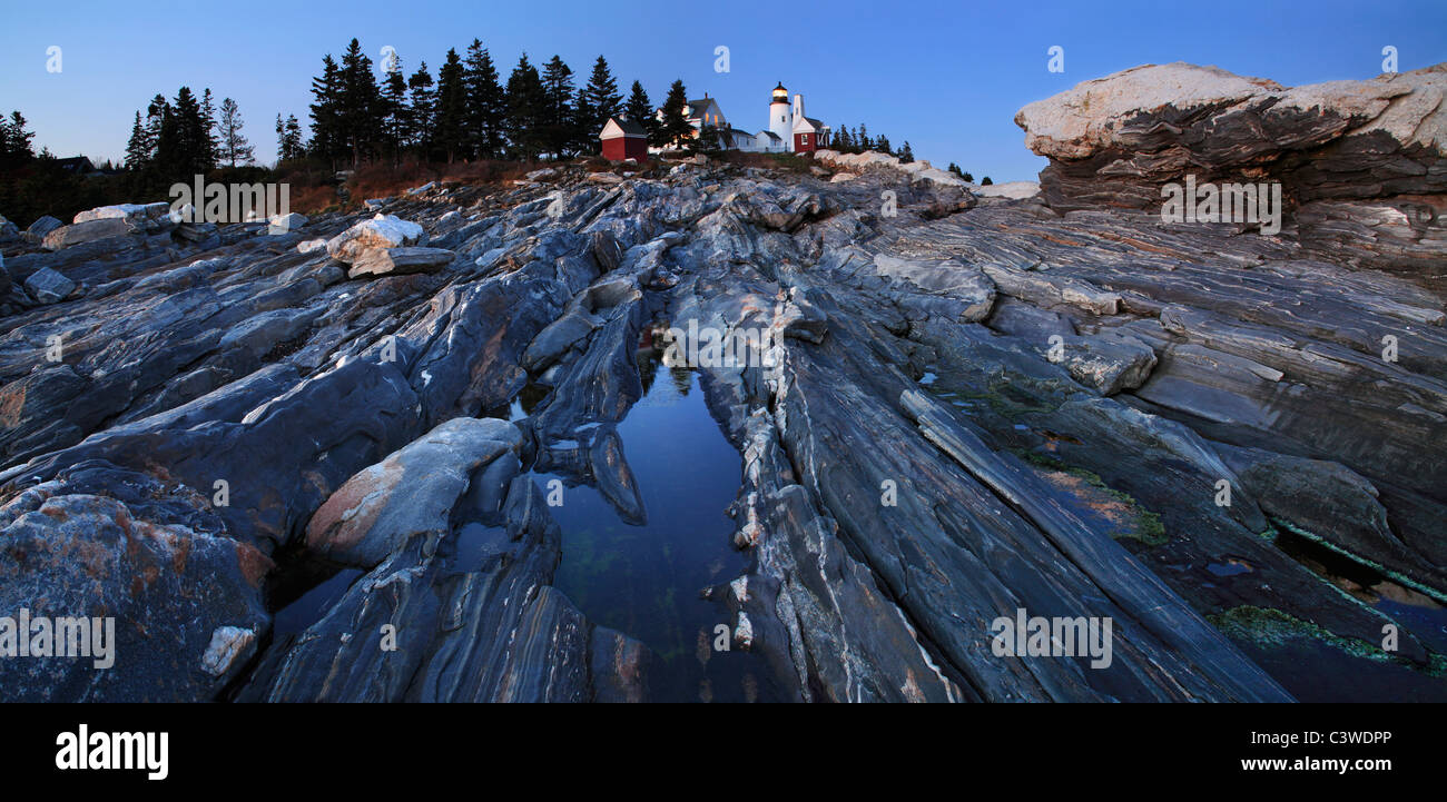 The Pre Dawn Night Is Turned To Daylight, The Rugged Sea Coast At The Foot Of The Pemaquid Point Lighthouse, Bristol Maine, USA Stock Photo