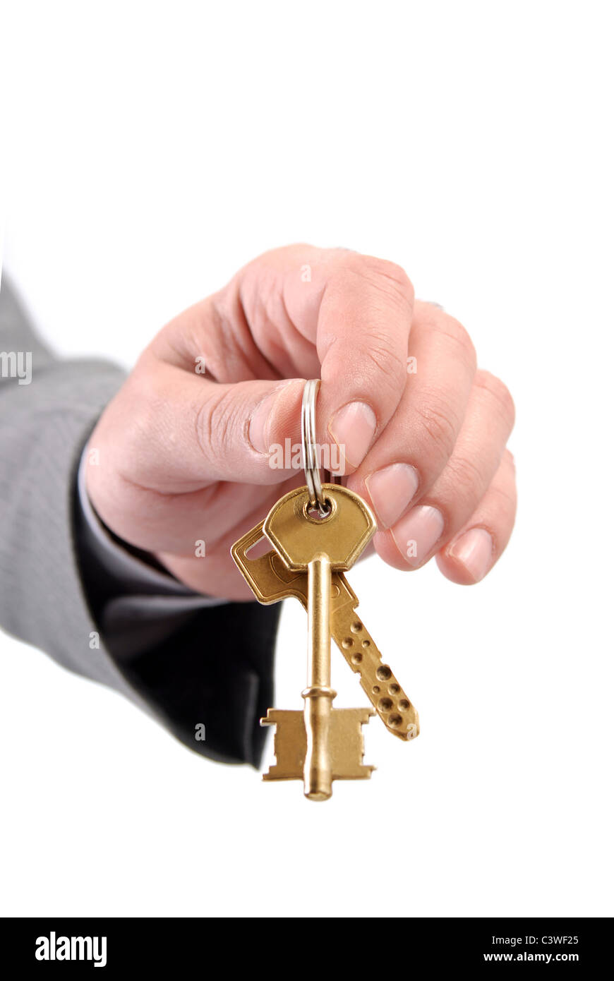 Close-up picture of a male real estate executive's hand holding two keys. Stock Photo