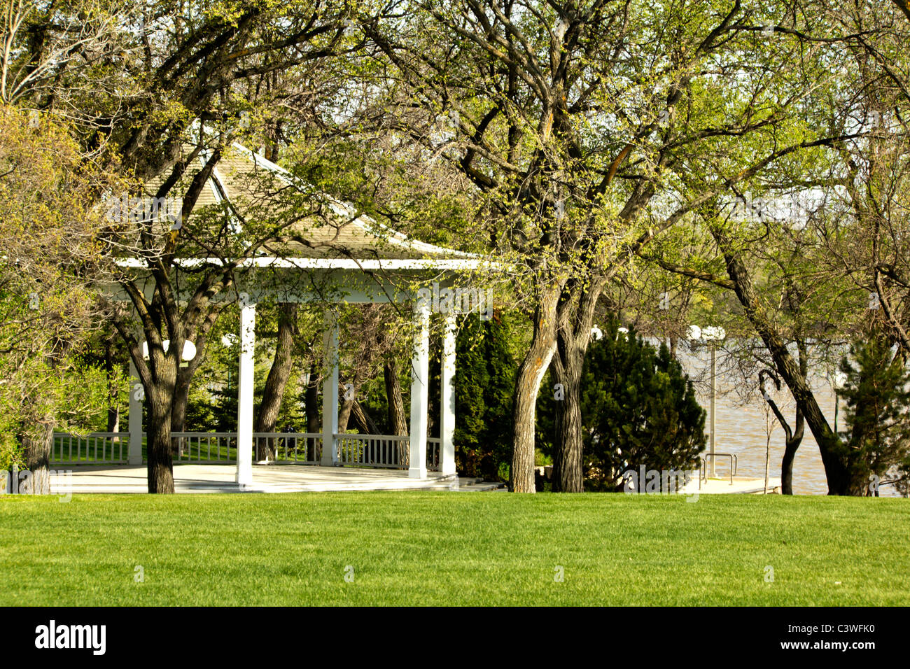 A white gazebo in a public park overseeing Wascana Lake Stock Photo