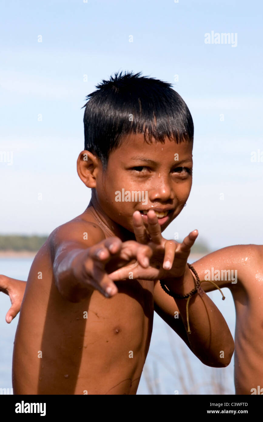 A young Asian boy is swimming and enjoying the water in the Mekong