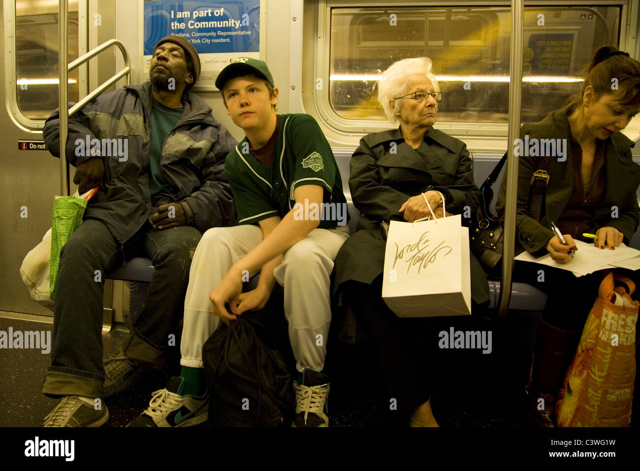 Riders on a New York City subway train Stock Photo